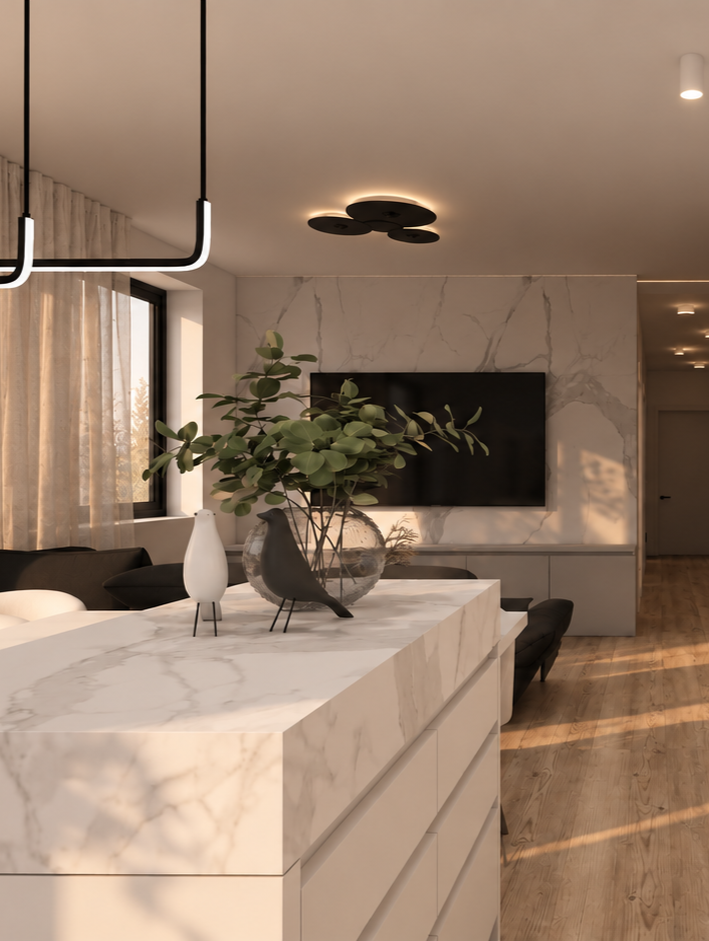 Luxurious marble island in a modern open-plan living room with a hanging light fixture and TV on a marble wall behind; potted plant centerpiece on the island.